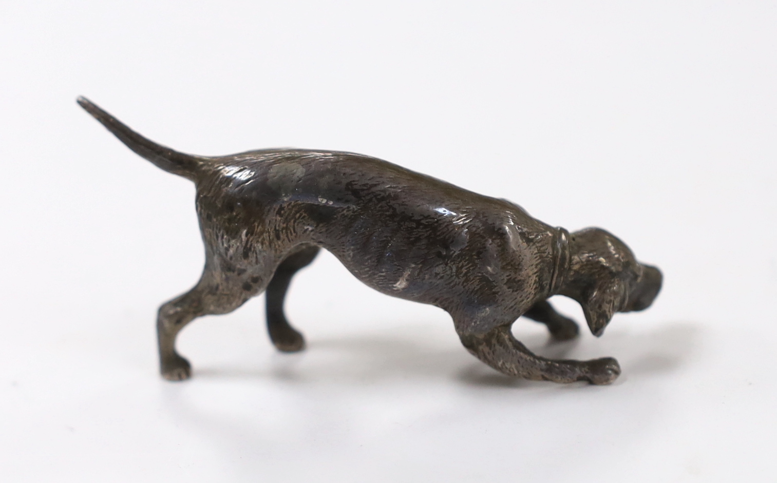 An Edwardian miniature silver model of a dog, import marks for Arthur Graf, Chester, 1905, length 76mm.